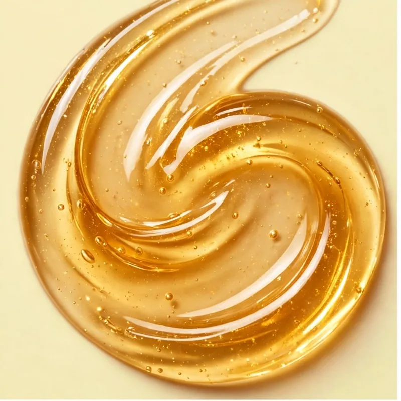 Golden translucent gel texture of the Sunshine Glow Mask, swirled